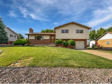 Charming two-story home with brick and siding exterior, well-manicured lawn, and attached one car garage at 10371 Monterey Cir, Northglenn, CO 80260