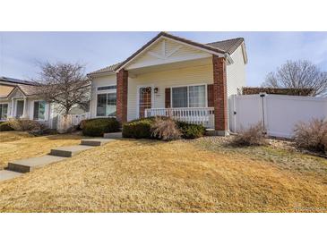 Charming single-Gathering home featuring a welcoming front porch, well-maintained landscaping, and a cozy curb appeal at 20764 E 47Th Ave, Denver, CO 80249