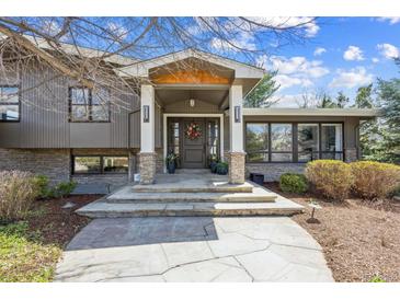 Inviting front entrance with stone accents, decorative wreath, and flagstone walkway create curb appeal at 5752 S Jasmine St, Greenwood Village, CO 80111