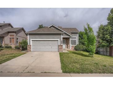 Charming single-Gathering home featuring a two-car garage and well-maintained front yard with mature trees at 19688 E Lasalle Dr, Aurora, CO 80013