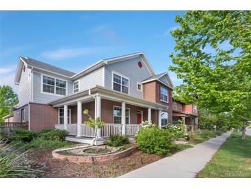 Charming two-story home with a welcoming front porch, landscaped garden, and beautiful curb appeal at 8029 E 23Rd Ave, Denver, CO 80238