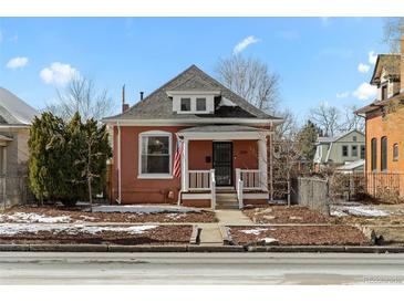 Charming brick home with a cozy front porch and manicured front yard at 2919 N York St, Denver, CO 80205