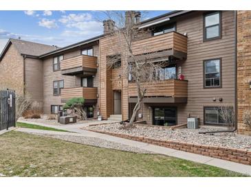 Inviting multi-story condo featuring private balconies, attractive landscaping, and a charming exterior at 203 Wright St # 102, Lakewood, CO 80228