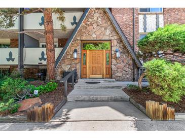 Charming entryway with stone facade and wooden door framed by decorative glass sidelights at 1260 York St # 204, Denver, CO 80206