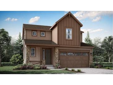 Two-story house with brown siding, attached garage, and landscaping at 7327 S Yank Ct, Littleton, CO 80123