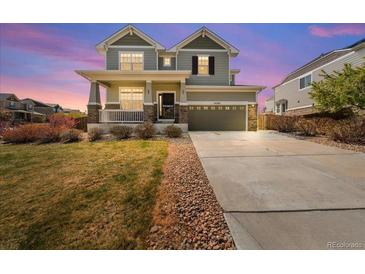 Charming two-story home with a welcoming porch and manicured front yard at 24394 E Dorado Pl, Aurora, CO 80016