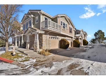 Two-story townhome with stone accents and attached garage at 9760 Mayfair St # A, Englewood, CO 80112