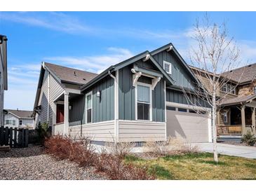 Charming home with two-car garage, blue and beige siding, and well-kept landscaping at 6311 Stable View St, Castle Pines, CO 80108