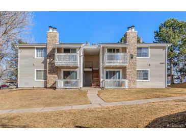 Inviting condo exterior featuring stone accents, balconies and well-maintained landscaping at 14182 E Colorado Dr # 204, Aurora, CO 80012