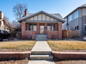 Charming brick home with a welcoming front porch and well-maintained lawn at 1444 Fairfax St, Denver, CO 80220