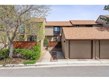 Cozy townhouse features a two-car garage with neutral color palette and mature landscape, creating a welcoming curb appeal at 4202 Greenbriar Blvd # 46, Boulder, CO 80305