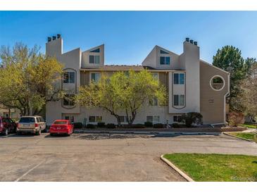 A three-story condominium building with unique architectural design and well-maintained landscaping at 4070 S Atchison Way # 203, Aurora, CO 80014