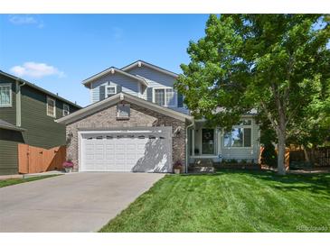 Charming two-story home featuring a well-maintained lawn, brick accents, and a spacious two-car garage at 19118 E Grand Cir, Aurora, CO 80015