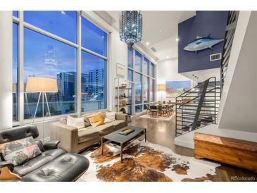 Bright living room with floor-to-ceiling windows, hardwood floors, comfortable seating, and modern decor, offering great city views at 55 W 12Th Ave # 608, Denver, CO 80204
