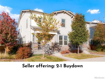 Charming two-story home featuring manicured lawn and colorful landscaping at 6041 N Orleans St, Aurora, CO 80019