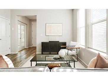 Bright living room with modern furniture, neutral decor, and natural light at 6041 N Orleans, Aurora, CO 80019