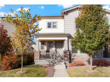 Charming two-story home featuring stone accents, a covered porch, and well-maintained landscaping at 6041 N Orleans St, Aurora, CO 80019