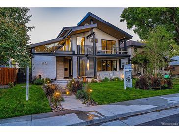 Striking modern two-story home featuring an eye-catching architectural design and a professionally landscaped front yard at 1175 S Jackson St, Denver, CO 80210