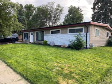 Charming single-story home with a well-maintained front yard and an inviting exterior at 6139 Broadway S, Littleton, CO 80121