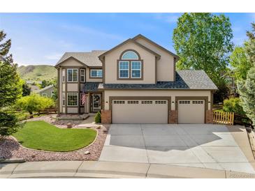 Charming two-story home featuring a three-car garage, landscaped front yard, and classic architectural details at 1825 Cooper Ct, Castle Rock, CO 80109