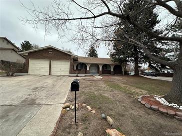 Charming brick ranch home with a two-car garage and covered front porch at 11306 E Colorado Dr, Aurora, CO 80012