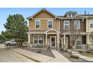 Charming two-story townhome with a cozy front porch and well-maintained landscaping at 15612 E 96Th Way # 29A, Commerce City, CO 80022