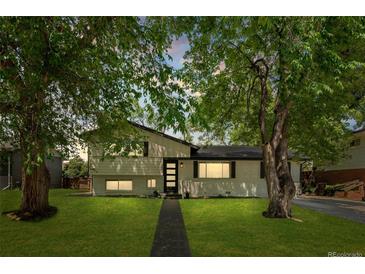 Charming two-story home with beautifully landscaped front yard and mature trees at 3545 Moorhead Ave, Boulder, CO 80305
