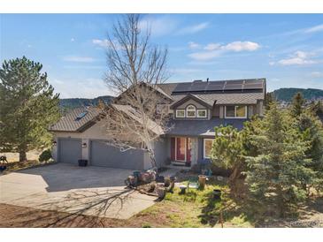 Charming home with a two-car garage, solar panels, and beautiful front yard landscaping and outdoor seating at 481 Sunrise Dr, Golden, CO 80401