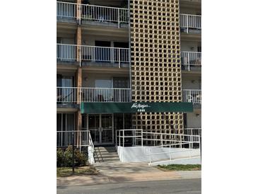 Building entrance with geometric design and covered awning, offering a unique and stylish welcome at 4801 E 9Th Ave # 108S, Denver, CO 80220