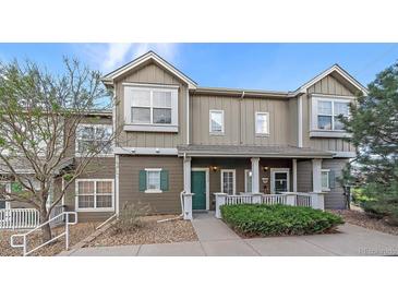 Charming townhome with a welcoming front porch, manicured landscaping, and a well-maintained exterior at 14700 E 104Th Ave # 1602, Commerce City, CO 80022
