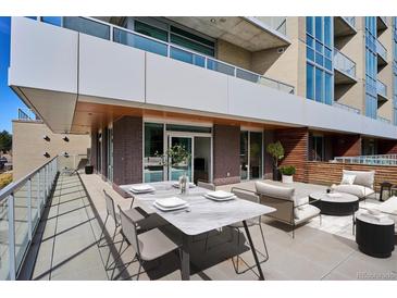 Stylish balcony featuring an outdoor dining and lounge area with sleek furniture and modern design elements at 4200 W 17Th Ave # 223, Denver, CO 80204