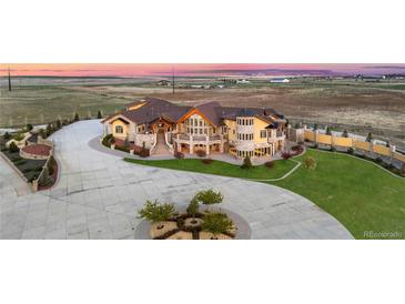Expansive estate boasting meticulous landscaping, and impressive stone and stucco detailing at 12565 Picadilly Rd, Commerce City, CO 80022