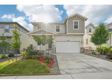 Charming two-story home featuring a covered porch, a two-car garage, and well-maintained landscaping at 8926 Swan River St, Littleton, CO 80125