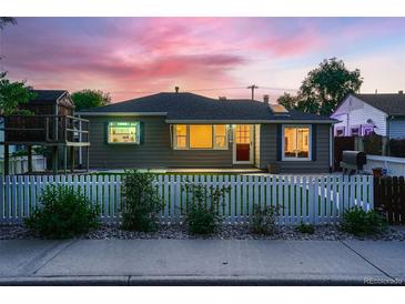 Charming single-story home with a well-maintained lawn, a quaint white picket fence, and colorful sunset sky at 4329 S Clarkson St, Englewood, CO 80113