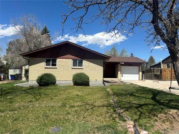 Charming single-story brick home with a well-maintained lawn and attached one car garage at 11623 E Virginia Dr, Aurora, CO 80012
