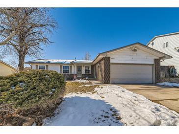 Brick ranch home with attached garage and landscaping, nestled on a snow-dusted lawn at 8839 Winona Ct, Westminster, CO 80031