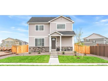 Charming two-story home with stone accents, well-manicured lawn, and inviting curb appeal at 22323 E 6Th Pl, Aurora, CO 80018