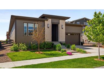 Modern home with a well-manicured lawn and beautiful landscaping adds curb appeal at 6530 Barnstead Dr, Castle Pines, CO 80108