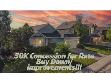 Charming home featuring well-manicured lawn, mature trees and a two-car garage at 15926 Butterwort Cir, Parker, CO 80134