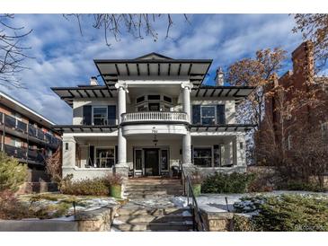 Grand two-story home with classic columns and a welcoming front porch at 750 N Clarkson St, Denver, CO 80218