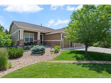 Charming home featuring a well-manicured lawn and stone accents, offering curb appeal at 15414 Xenia Ct, Thornton, CO 80602