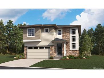 Beautiful two-story home featuring a stone and siding exterior with a two-car garage and manicured lawn at 454 S Rifle St, Aurora, CO 80017