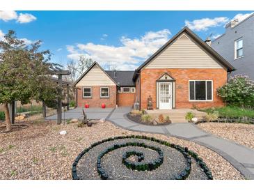Charming brick home featuring a unique rock garden and inviting walkway to the front entrance at 1748 S Logan St, Denver, CO 80210