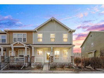 Charming two-story townhome with a cozy front porch and manicured landscaping at 15612 E 96Th Way # 20H, Commerce City, CO 80022