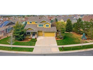 An aerial view of a two-story home with a three-car garage and well-maintained lawn at 25362 E Indore Dr, Aurora, CO 80016