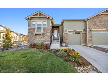 Craftsman style home with attractive landscaping and two-car garage at 7870 Slate River St, Littleton, CO 80125