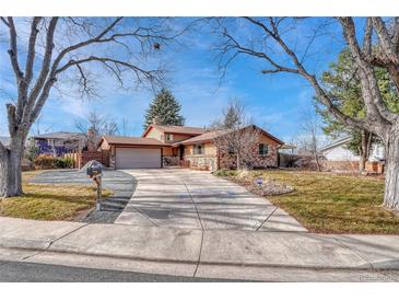 Charming single-Gathering home featuring a beautiful brick and siding exterior, driveway, and mature trees at 12738 E Exposition Dr, Aurora, CO 80012