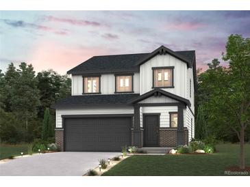 Charming two-story home with a gray garage door, a manicured lawn, and beautiful landscaping at 2161 Flower Blossom Ave, Brighton, CO 80601