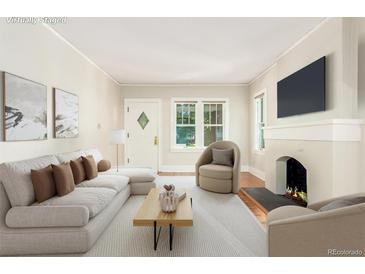 Bright living room features a fireplace, hardwood floors, and an abundance of natural light at 618 Milwaukee St, Denver, CO 80206