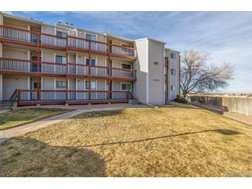 Exterior of a two-story condo building with balconies and grassy area at 2725 W 86Th Ave # 5, Westminster, CO 80031